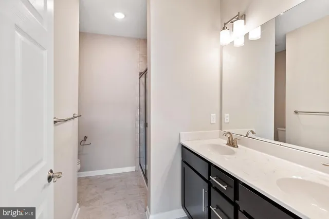 a bathroom with a sink vanity and a mirror