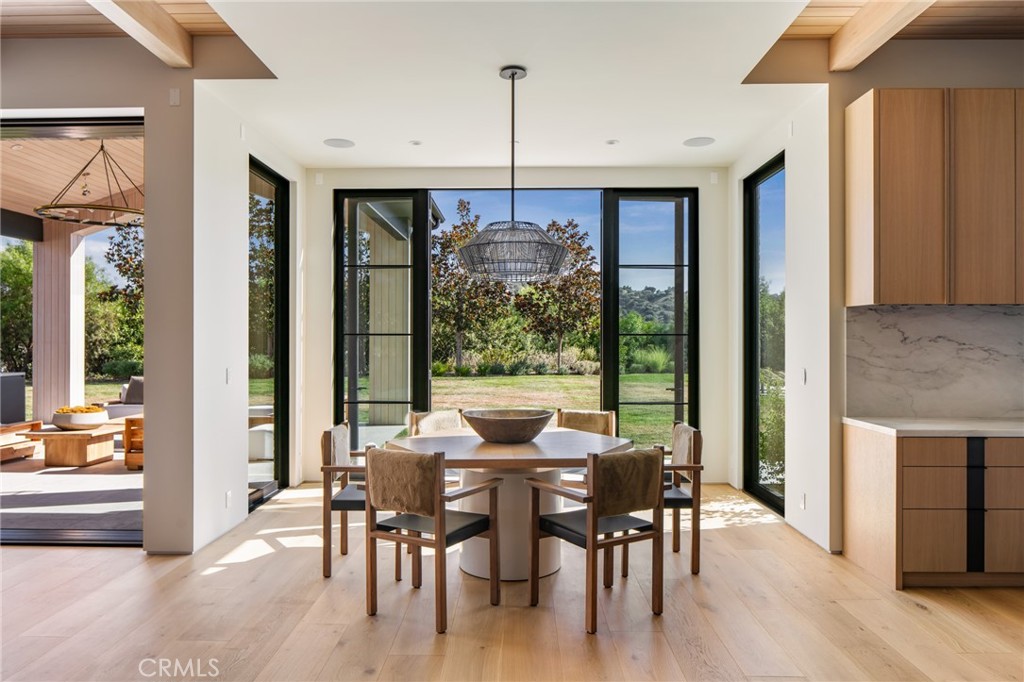 24050 Hidden Ridge Road Hidden Hills, CA 91302 - Photo 11 of 45 a view of a dining room with furniture window and wooden floor