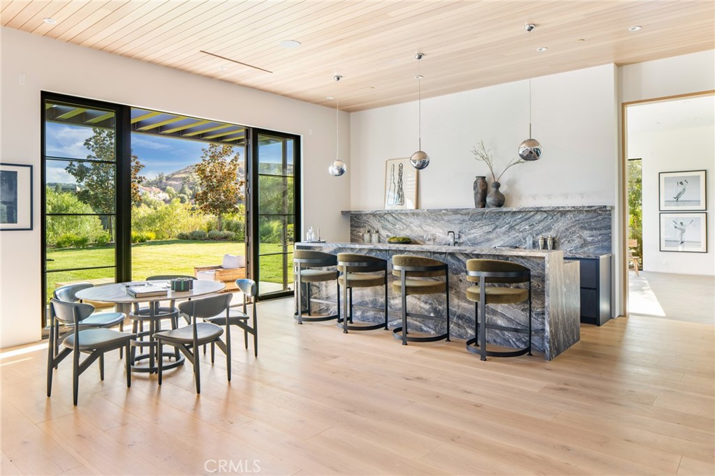 24050 Hidden Ridge Road Hidden Hills, CA 91302 - Photo 13 of 45 a living room with furniture and a fireplace
