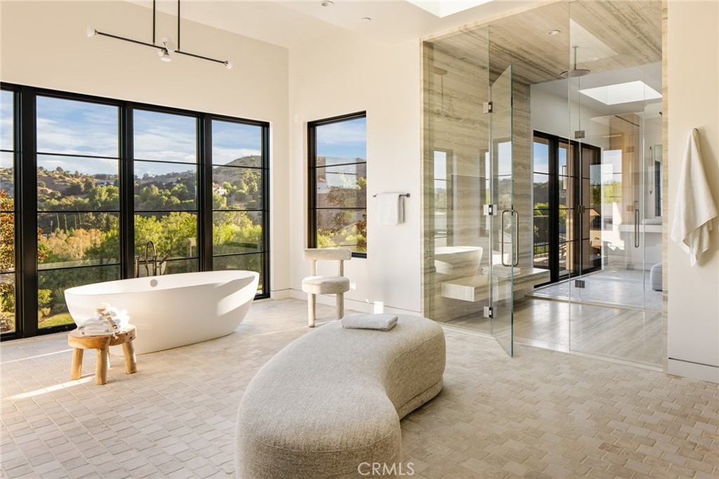 24050 Hidden Ridge Road Hidden Hills, CA 91302 - Photo 23 of 45 a living room with furniture and large windows