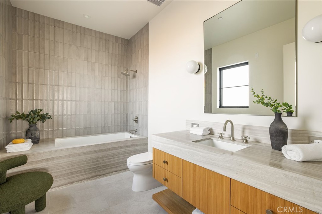 24050 Hidden Ridge Road Hidden Hills, CA 91302 - Photo 28 of 45 a bathroom with a granite countertop sink mirror toilet and bathtub