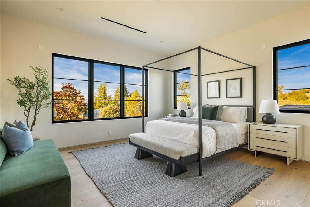 24050 Hidden Ridge Road Hidden Hills, CA 91302 - Photo 30 of 45 a spacious bedroom with a bed and window