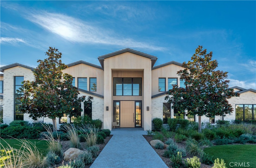 24050 Hidden Ridge Road Hidden Hills, CA 91302 - Photo 3 of 45 a front view of a house with garden