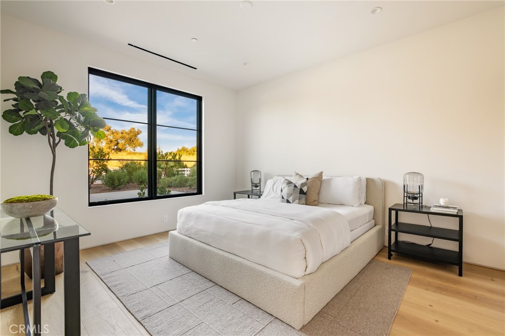 24050 Hidden Ridge Road Hidden Hills, CA 91302 - Photo 31 of 45 a bedroom with a bed and a window