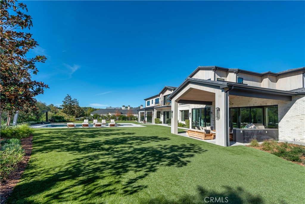 24050 Hidden Ridge Road Hidden Hills, CA 91302 - Photo 35 of 45 a front view of a house with a garden