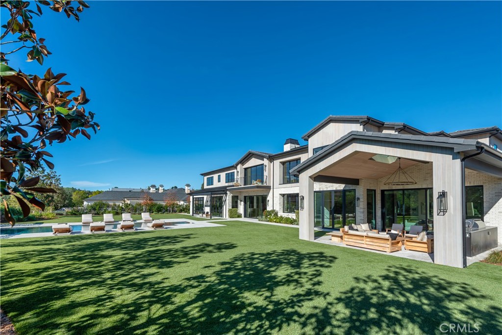 24050 Hidden Ridge Road Hidden Hills, CA 91302 - Photo 36 of 45 a front view of a house with a garden