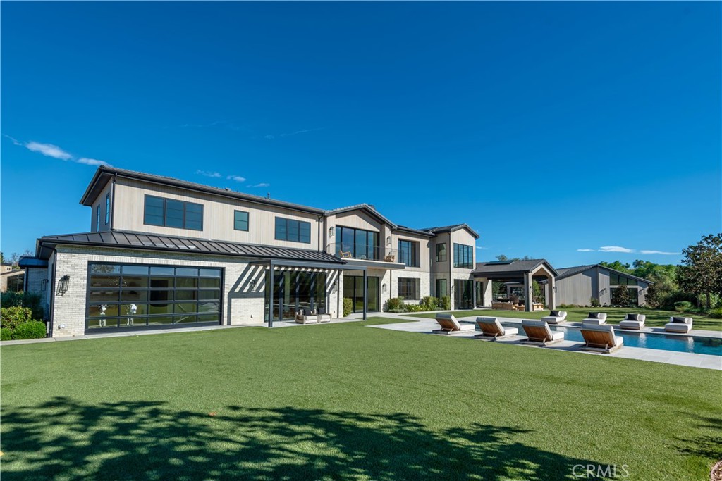 24050 Hidden Ridge Road Hidden Hills, CA 91302 - Photo 37 of 45 a front view of a house with a yard