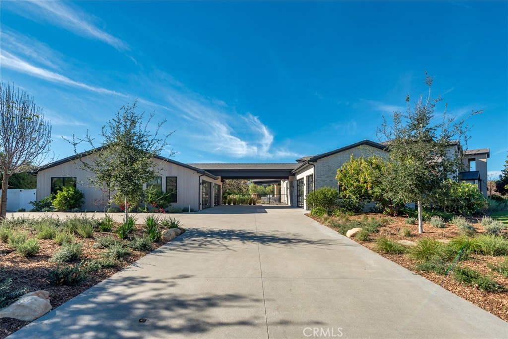 24050 Hidden Ridge Road Hidden Hills, CA 91302 - Photo 44 of 45 a front view of a house with a yard and garage