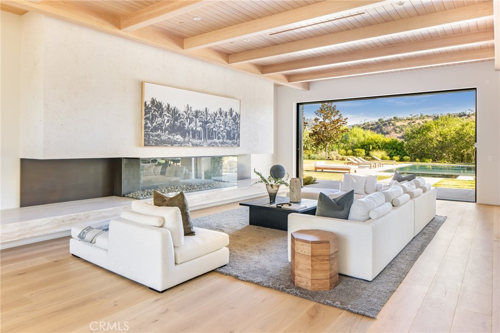 24050 Hidden Ridge Road Hidden Hills, CA 91302 - Photo 6 of 45 a living room with furniture and a large window