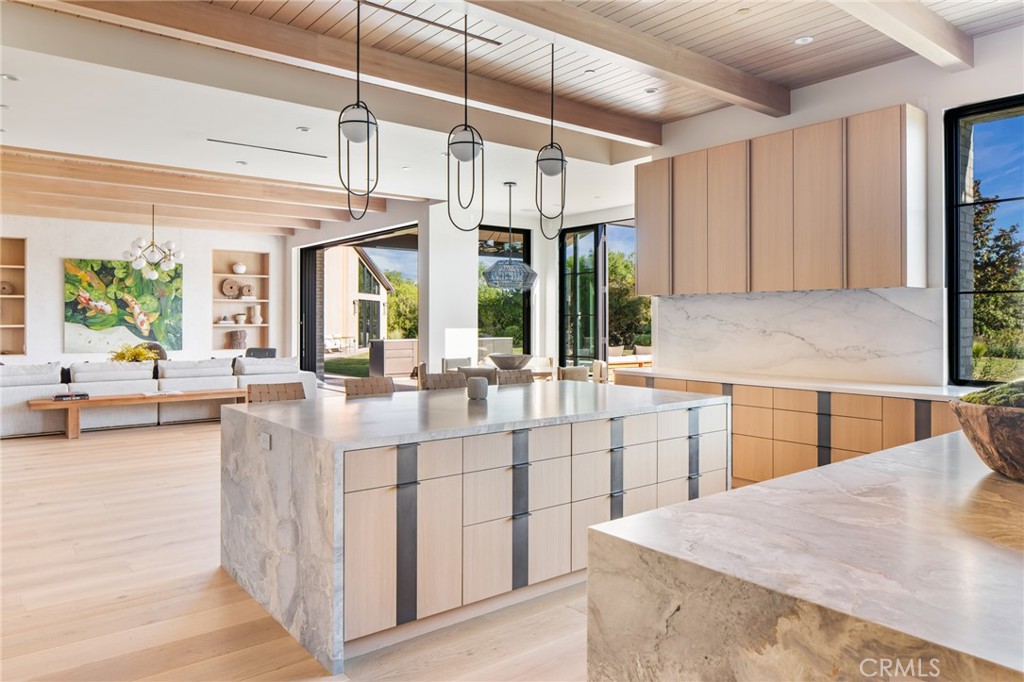 24050 Hidden Ridge Road Hidden Hills, CA 91302 - Photo 10 of 45 a kitchen with stainless steel appliances kitchen island granite countertop a sink and cabinets