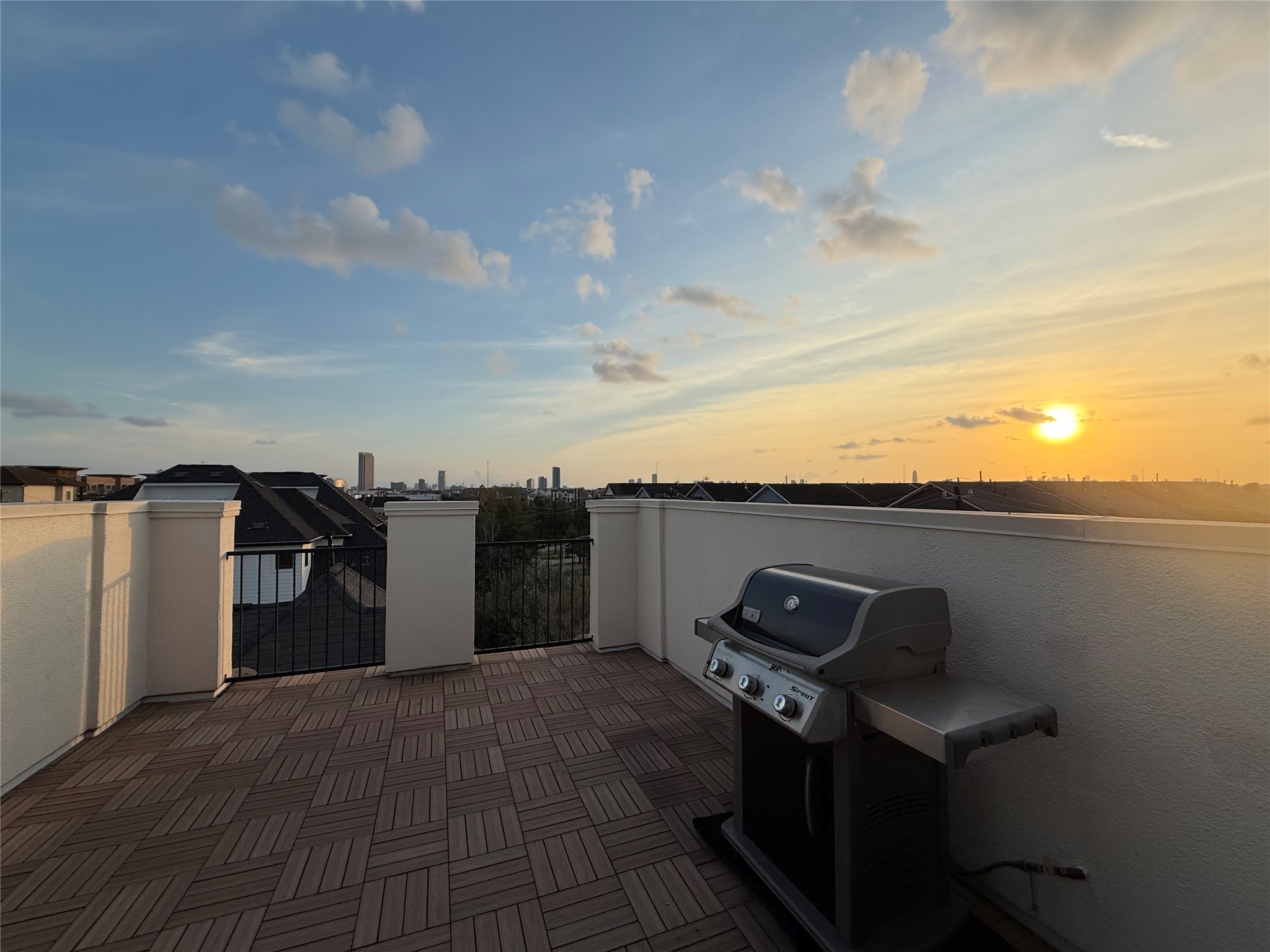620 Rutland Street, Unit A Houston, TX 77007 - Photo 30 of 46 Spacious rooftop terrace with a barbecue grill, offering stunning sunset views over the city skyline. Perfect for outdoor entertaining and relaxation.