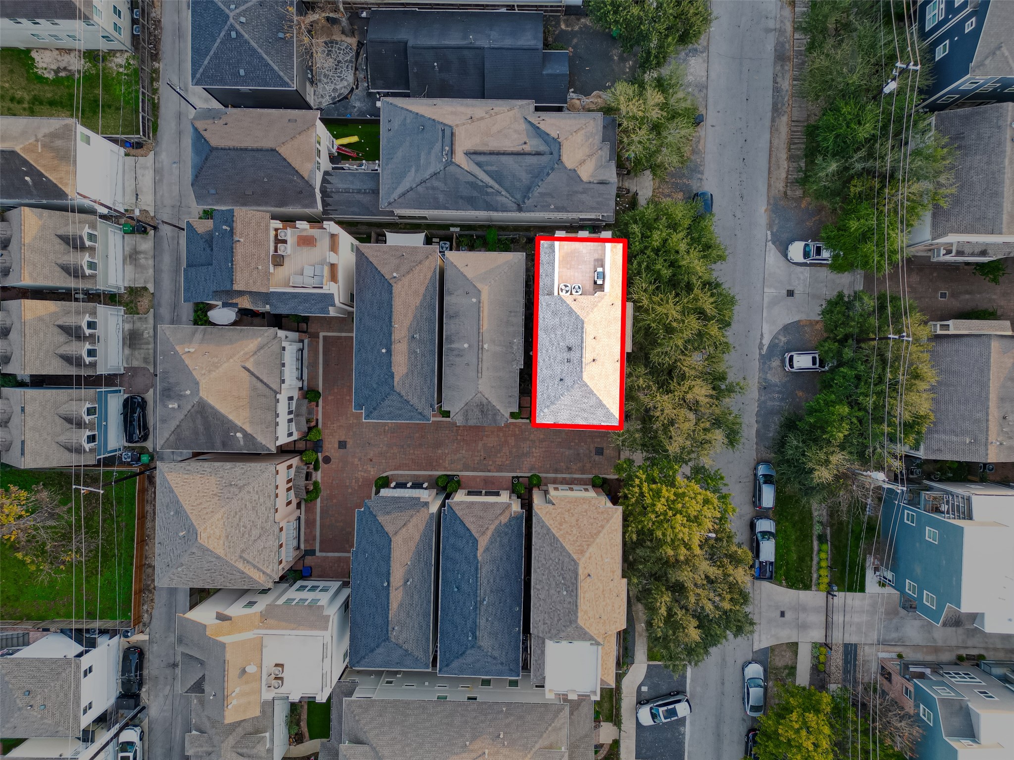 620 Rutland Street, Unit A Houston, TX 77007 - Photo 39 of 46 This aerial photo shows a densely packed residential area with a highlighted property. It features a mix of single-family homes with varying roof styles and a central courtyard. The neighborhood is lined with trees and has accessible streets, offering a cozy and organized community layout.