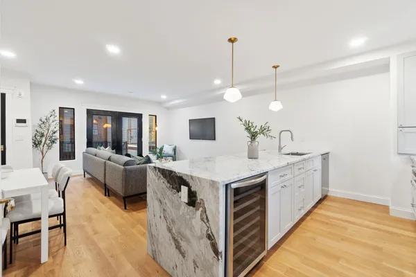 a large kitchen with stainless steel appliances kitchen island a large island in the center