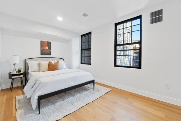 a bedroom with a bed and a dresser