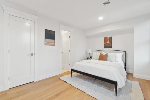 a bedroom with a bed and a large window