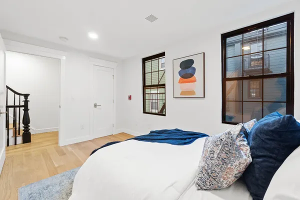 a bedroom with a bed and a mirror