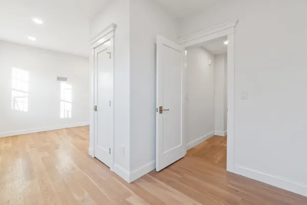 an empty room with closet and a window