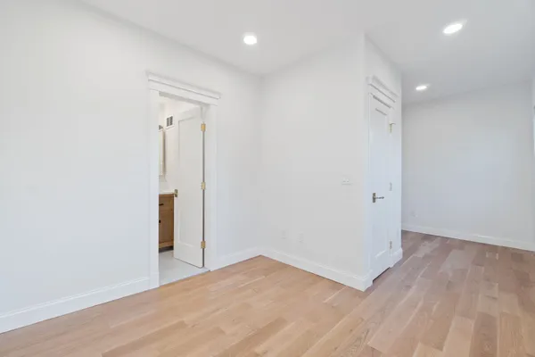 a storage room with water heater and refrigerator