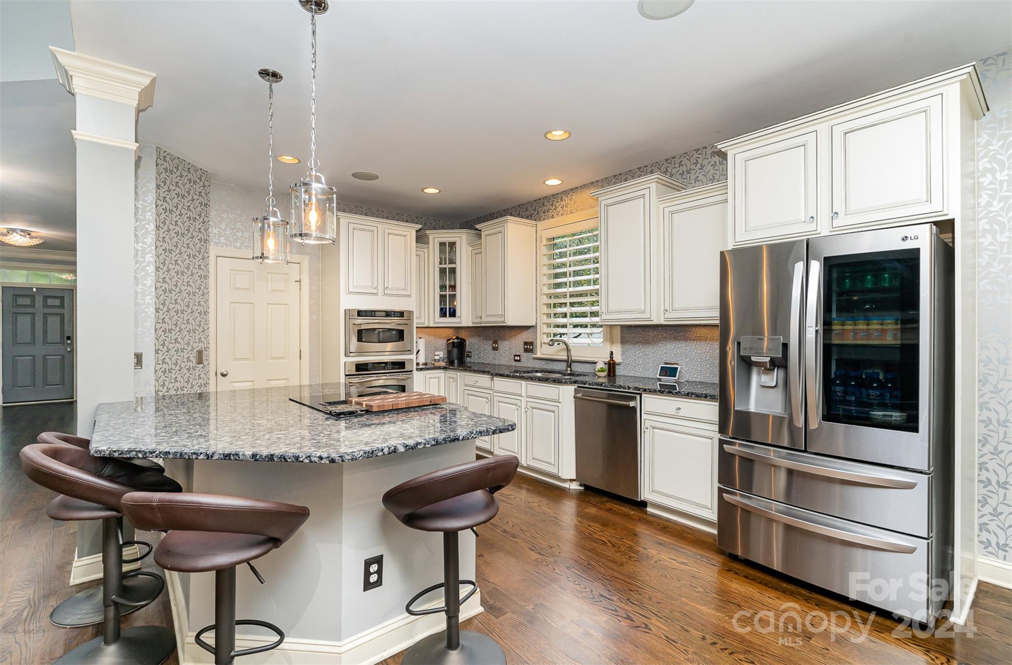 5324 Maddox Court Fort Mill, SC 29708 - Photo 14 of 48 a kitchen with stainless steel appliances kitchen island granite countertop a stove refrigerator and cabinets