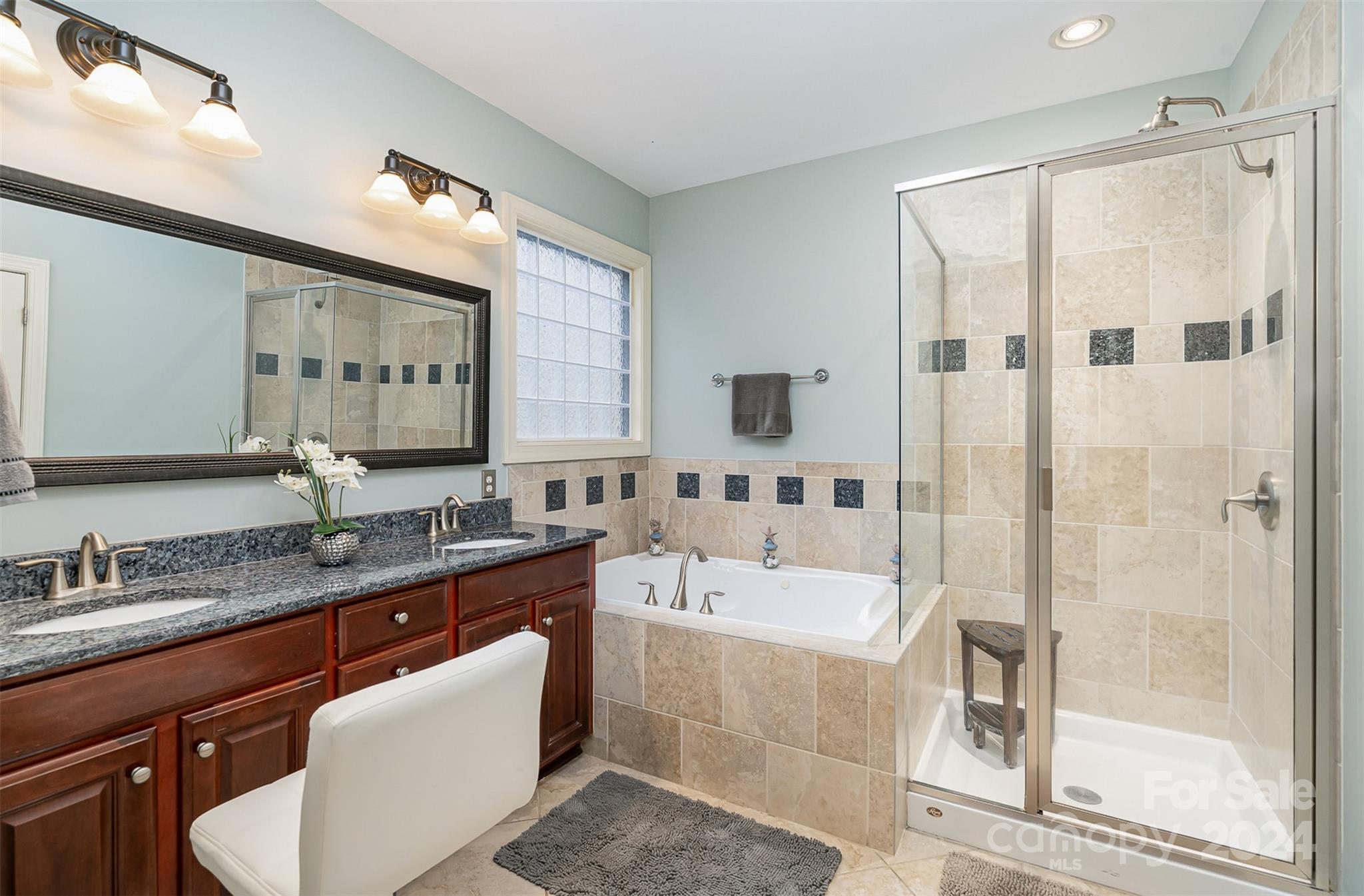 5324 Maddox Court Fort Mill, SC 29708 - Photo 22 of 48 a bathroom with a granite countertop sink mirror and a bathtub