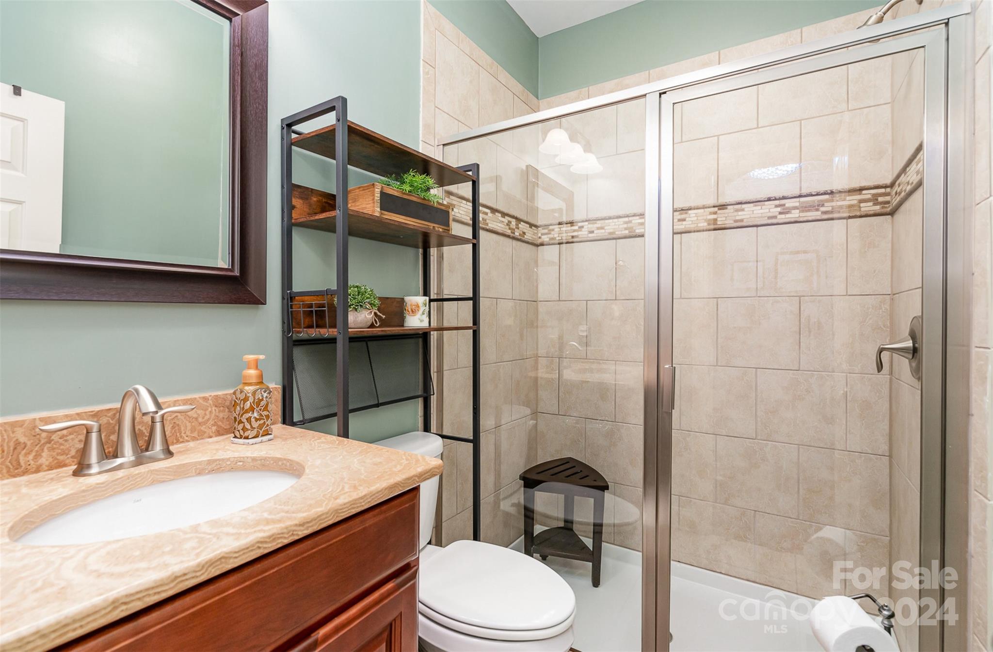 5324 Maddox Court Fort Mill, SC 29708 - Photo 26 of 48 a bathroom with a granite countertop sink toilet a mirror and shower