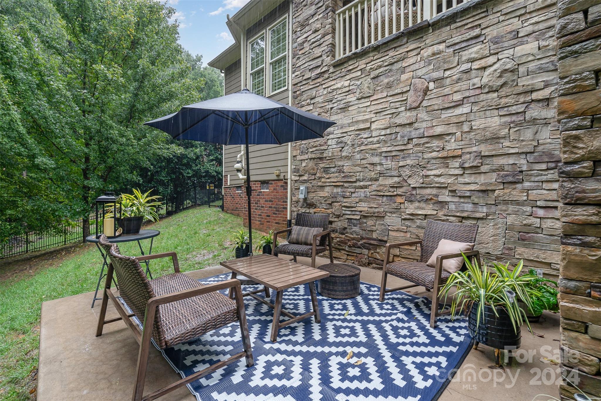 5324 Maddox Court Fort Mill, SC 29708 - Photo 39 of 48 an outdoor sitting area with furniture and an umbrella