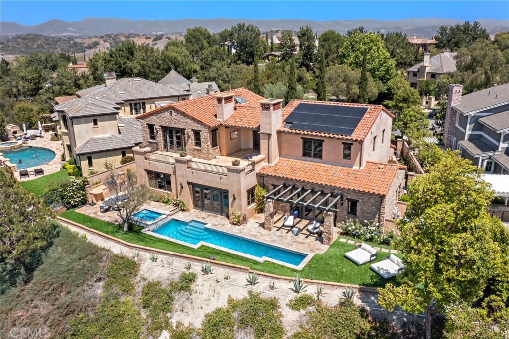 an aerial view of multiple houses with a yard