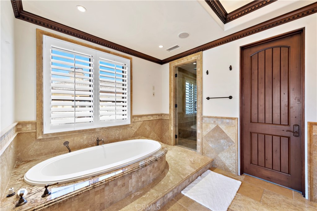 3 Fox Hole Road Ladera Ranch, CA 92694 - Photo 27 of 57 a bathroom with a tub a sink and a large mirror