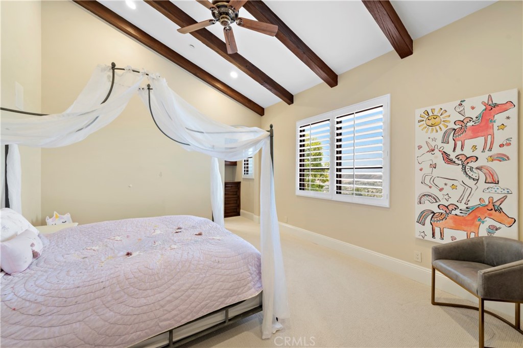 3 Fox Hole Road Ladera Ranch, CA 92694 - Photo 30 of 57 a spacious bedroom with a bed a couch and a painting on the wall