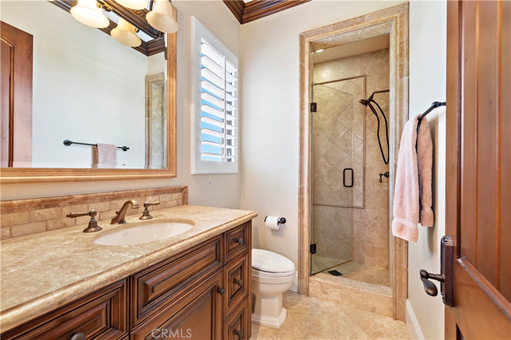 3 Fox Hole Road Ladera Ranch, CA 92694 - Photo 32 of 57 a bathroom with a granite countertop sink a mirror and a shower