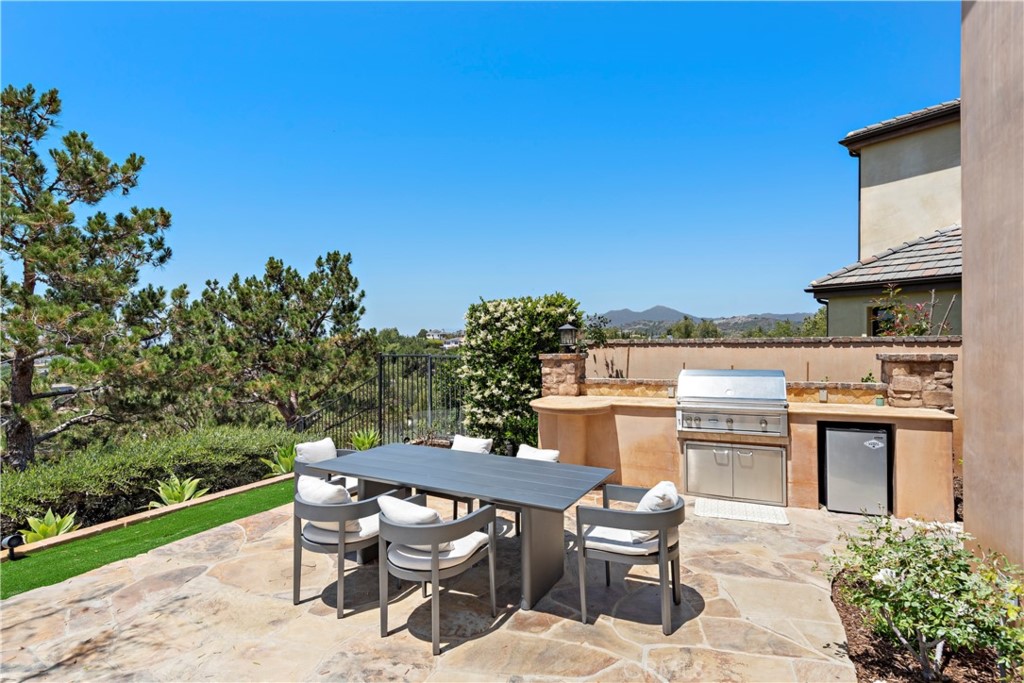 3 Fox Hole Road Ladera Ranch, CA 92694 - Photo 41 of 57 a patio with a table and chairs and potted plants