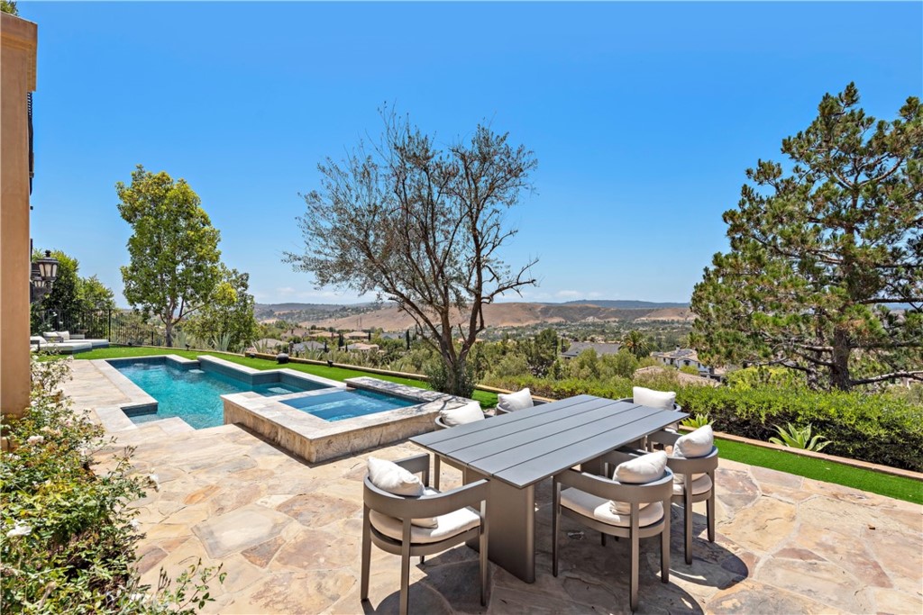 3 Fox Hole Road Ladera Ranch, CA 92694 - Photo 43 of 57 a view of a patio with table and chairs and potted plants with wooden floor and fence