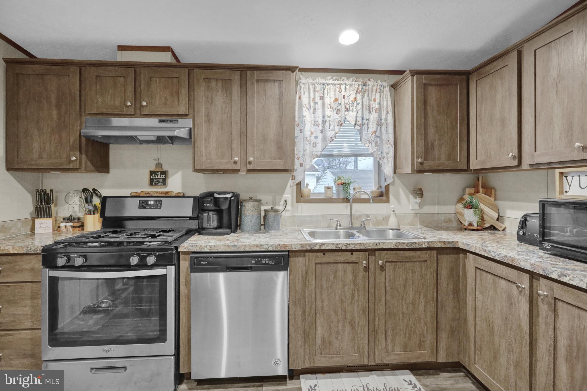 21 Keystone Road Reading, PA 19606 - Photo 8 of 22 a kitchen with granite countertop a sink stove and cabinets