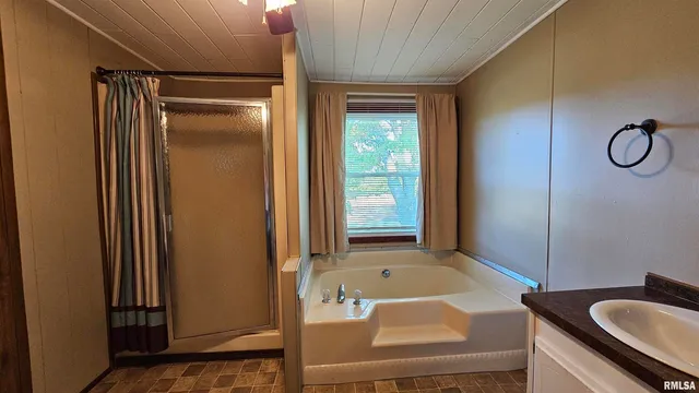 a utility room with a sink a cabinetry and a mirror