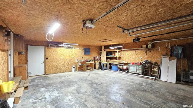 a view of a brick house with a small yard and wooden fence