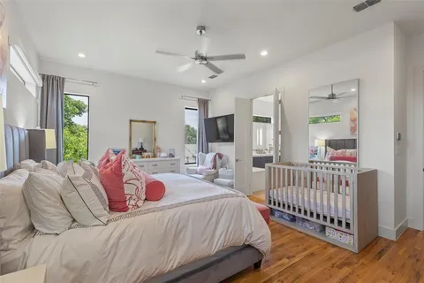 a bedroom with a bed and a large window