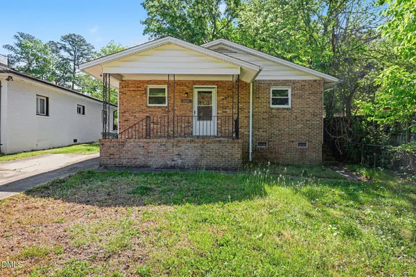 a view of a house with a yard and a garden