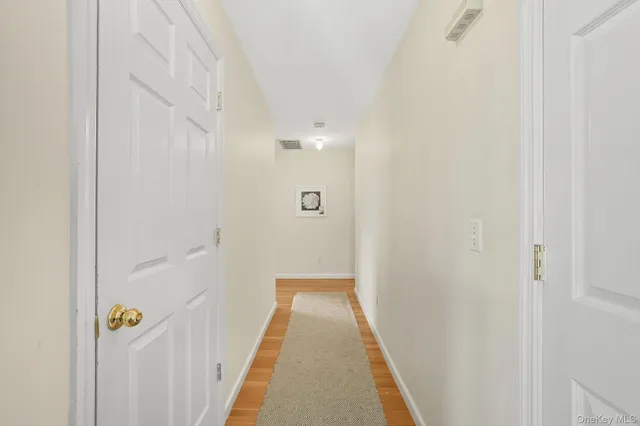 a spacious bedroom with a bed and a wooden floor