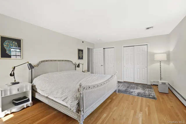 a spacious bedroom with a bed and a flat screen tv