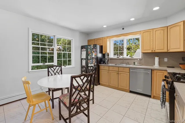 a kitchen with stainless steel appliances granite countertop a sink a refrigerator and cabinets