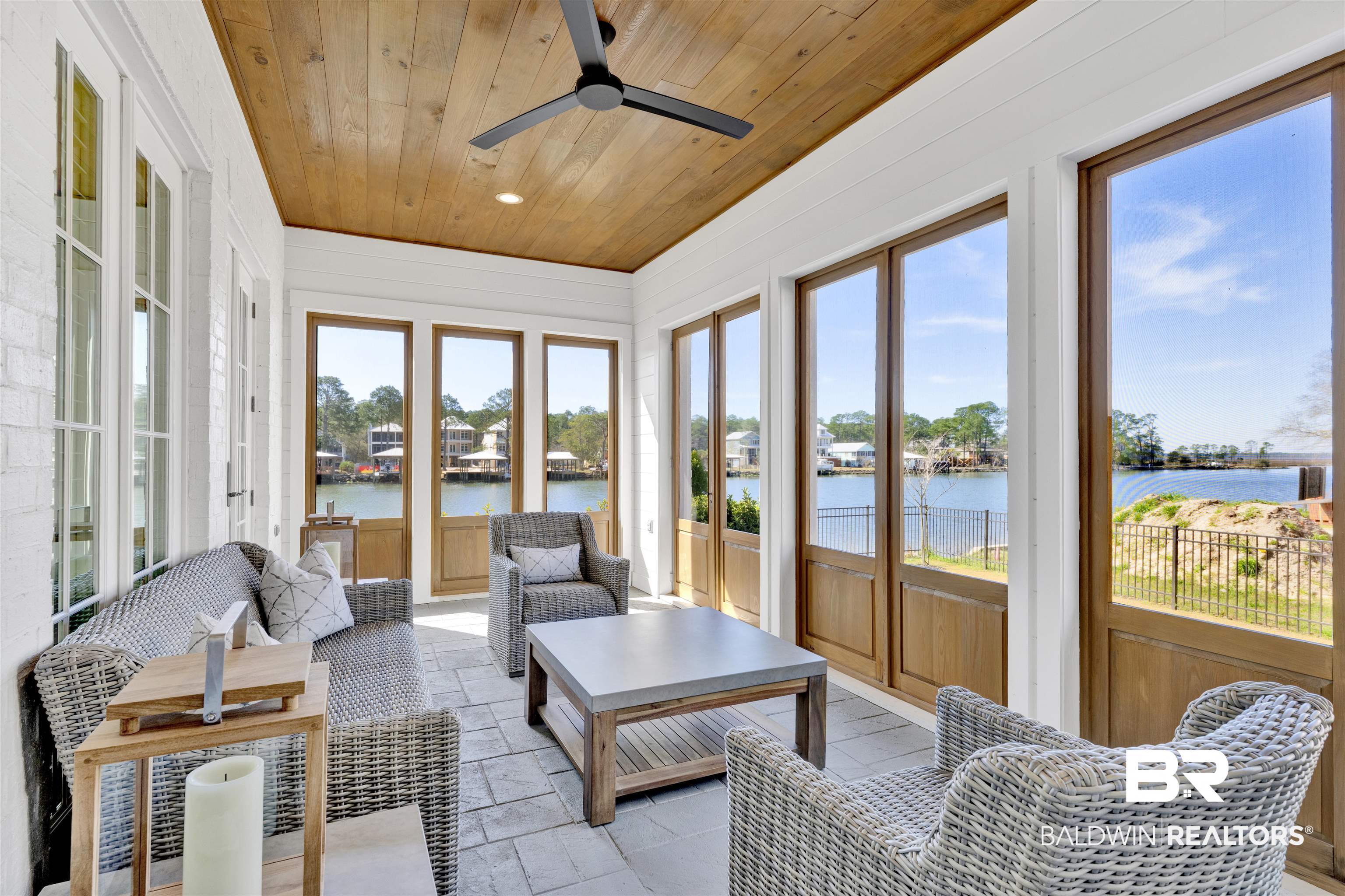 861 Inlet Circle Gulf Shores, AL 36542 - Photo 12 of 54 Sunroom featuring stone tile flooring, wood ceiling, and a water view