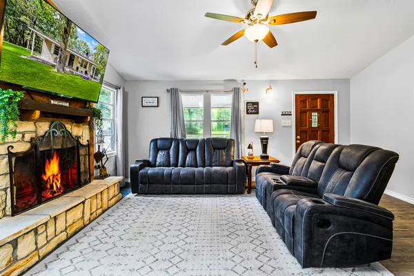 a large white kitchen with cabinets a sink a window and stainless steel appliances
