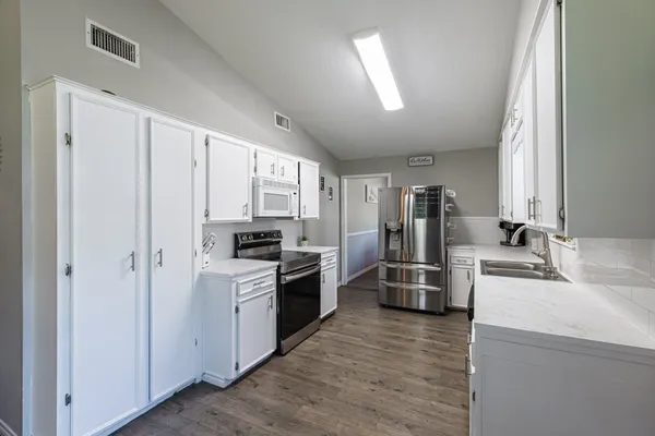 a bedroom with a bed and a chandelier