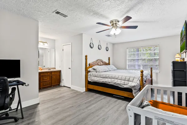 a bedroom with furniture and a wooden floor
