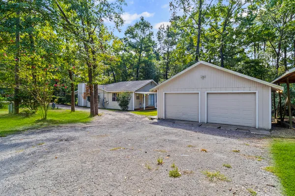 a front view of house with a garden and patio