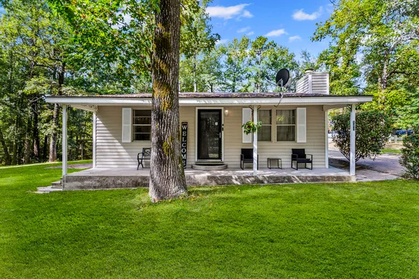 a front view of house with yard and green space