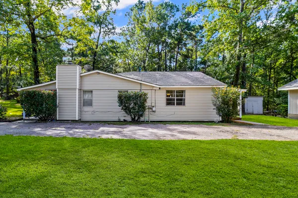a view of an house with backyard space and garden
