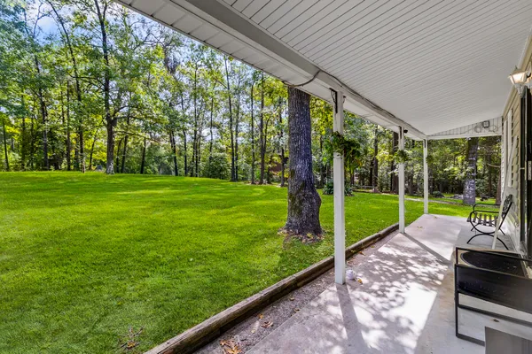 a living room with furniture a ceiling fan and a rug