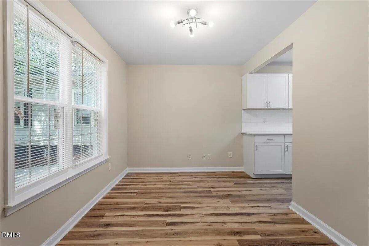 1611 Poole Road Raleigh, NC 27610 - Photo 12 of 19 a view of a room with wooden floor and windows
