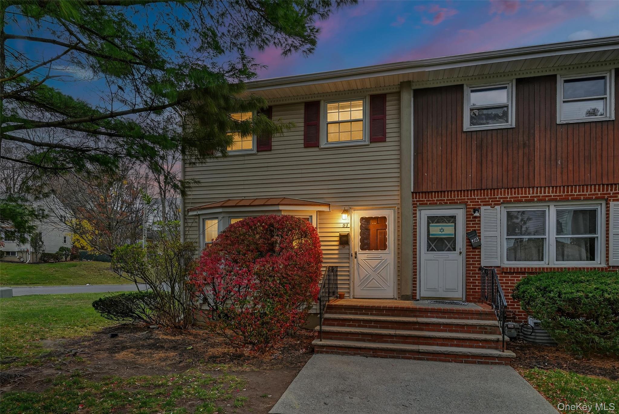 a front view of a house with a garden